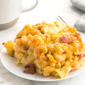 A plate of bacon and egg mac and cheese, ready to serve for dinner or as a side.