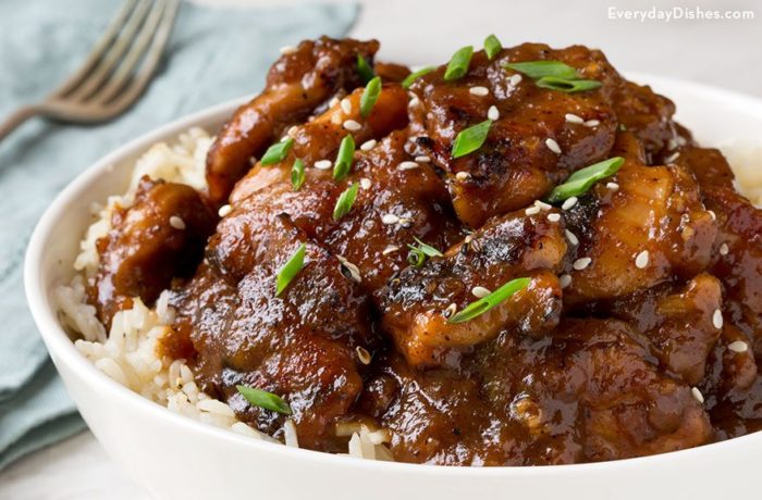 Easy bourbon chicken, in a bowl and served with rice.