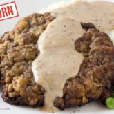 A homemade einkorn chicken fried steak and gravy, served and ready for dinner.