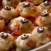 A skillet of spooky Halloween meatballs with eyes.
