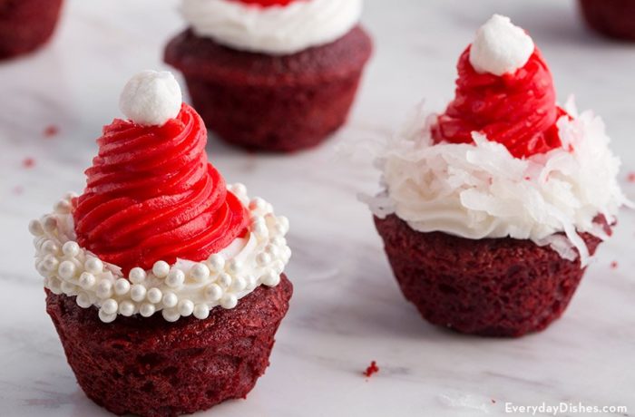 A batch of bite-sized cupcakes decorated to look like Santa hats.