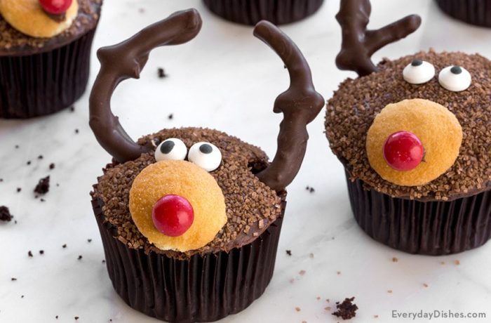 A batch of chocolate cupcakes decorated to look like reindeer.