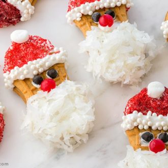 A batch of Nutter Butter cookies that are decorated to look like Santa.