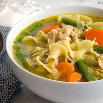 A bowl of homemade chicken noodle soup that's ready to eat.