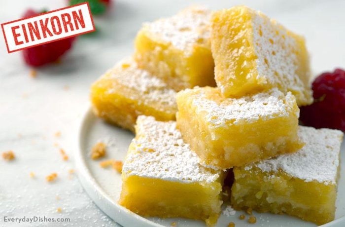 A plate piled with delicious lemon bars made with einkorn flour and sprinkled with powdered sugar.