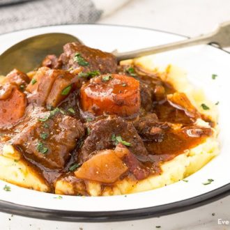 A bowl of Guinness beef stew with mashed potatoes.