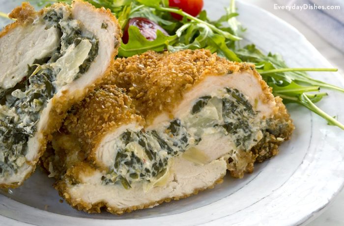 A plate with a delicious spinach artichoke dip stuffed chicken, a great dinner.