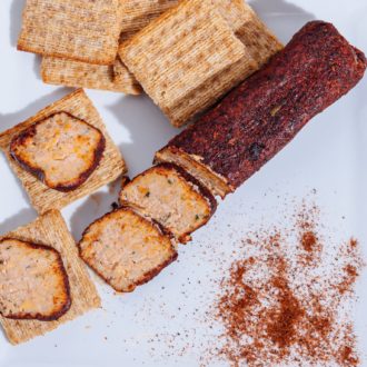 A fresh chili cheese roll, served on crackers. The perfect addition to a charceuterie board.