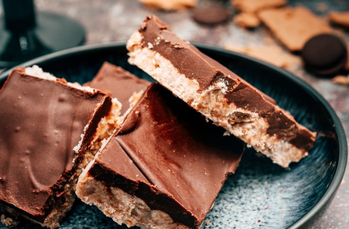 Chocolate peanut butter squares on a plate, a great dessert or snack for kids.
