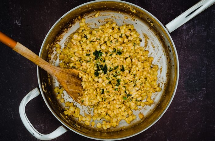 A skillet full of Mexican street corn, ready to serve.
