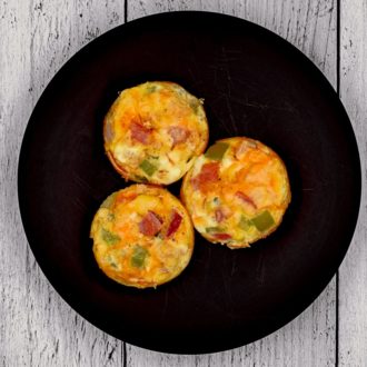 Three egg bites on a plate, a healthy breakfast to enjoy.