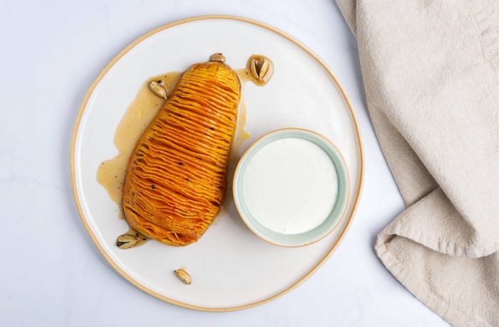 A Hasselback butternut squash, on a plate and ready to eat