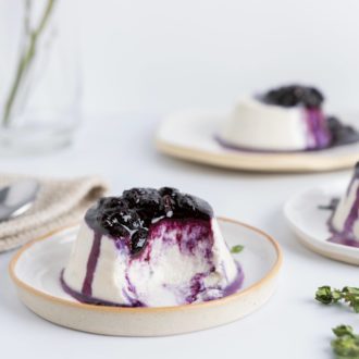 The vegan dessert coconut milk panna cotta with blueberries and thyme, ready to enjoy