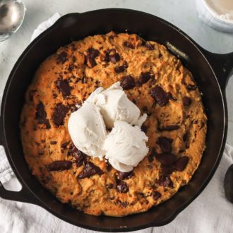 A delicious paleo skillet cookie topped with vanilla ice cream