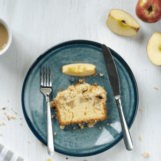 A slice of apple bread, on a plate and ready to enjoy.