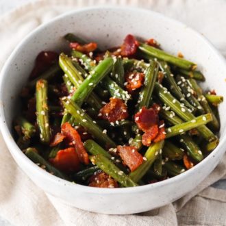 A bowl of sauteed green beans with bacon