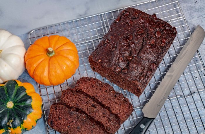 A loaf of chocolate pumpkin bread, sliced and ready to eat.