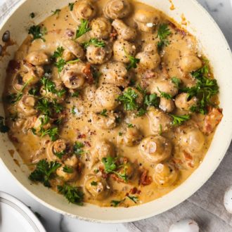 A bowl of creamy garlic mushrooms, a delicious keto-friendly side dish.