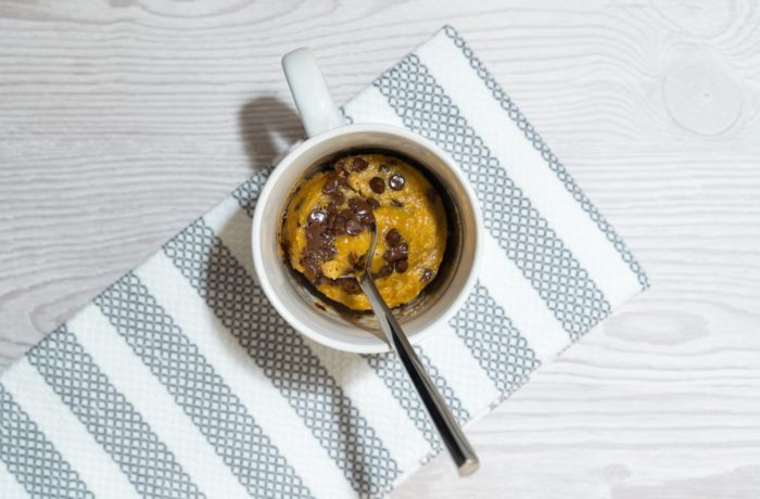 A chocolate chip mug cake that was made in the microwave.