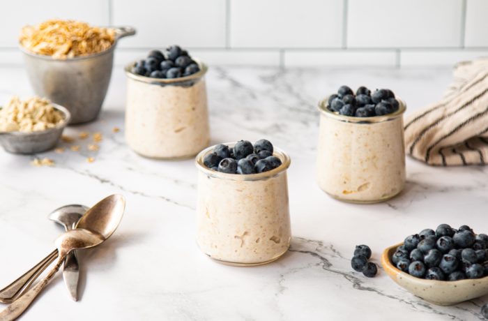 Bowls of high-protein overnight oats, with blueberries, ready to give your day a great start