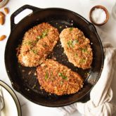 A skillet of almond crusted chicken — a macro friendly dinner.