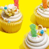 Cupcakes topped with Sour Patch Kids and candy pop.