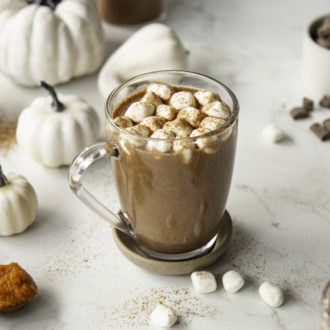A mug of pumpkin spice hot chocolate with marshmallows. A macro diet friendly drink.