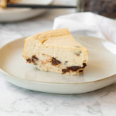 A delicious slice of high-protein cookie dough cheesecake.