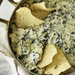A pot of spinach and artichoke dip. A high protein snack for a Superbowl party.