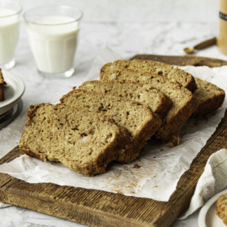 A sliced loaf of homemade protein banana bread. A macro-friendly breakfast or snack!
