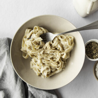 A bowl of pasta with a homemade high-protein alfredo sauce.