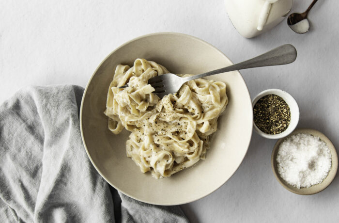A bowl of pasta with a homemade high-protein alfredo sauce.